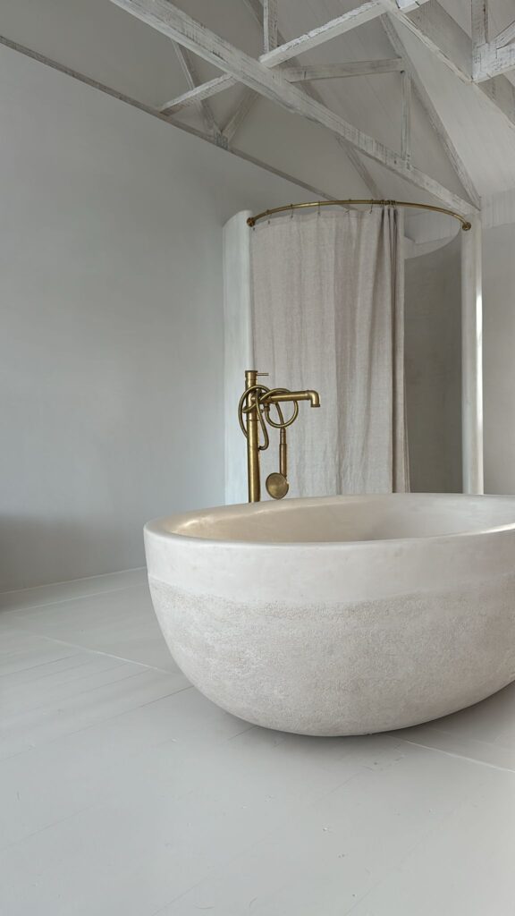 A Stonecast Bathsheba Bath with copper tap