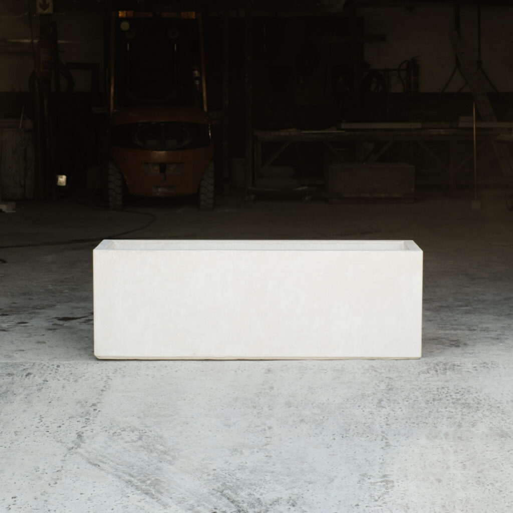 Side view of the Stonecast 'Stonecast Trough' in sandstone white.