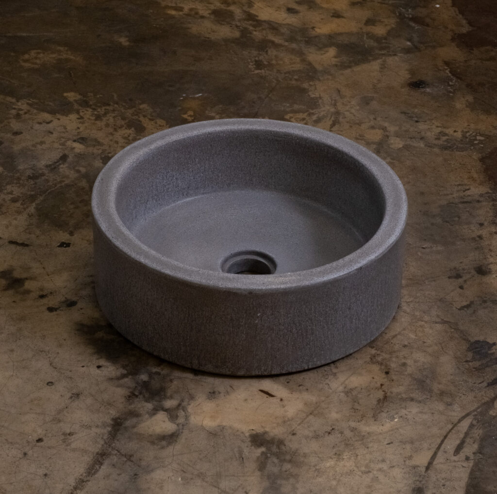 Side view of Stonecast's Mini Hatbox basin in Portland Grey