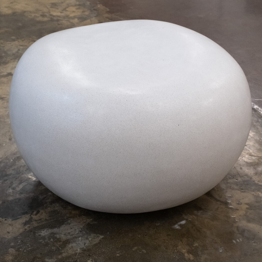 Side view of the small Stonecast Pebble Bench in white