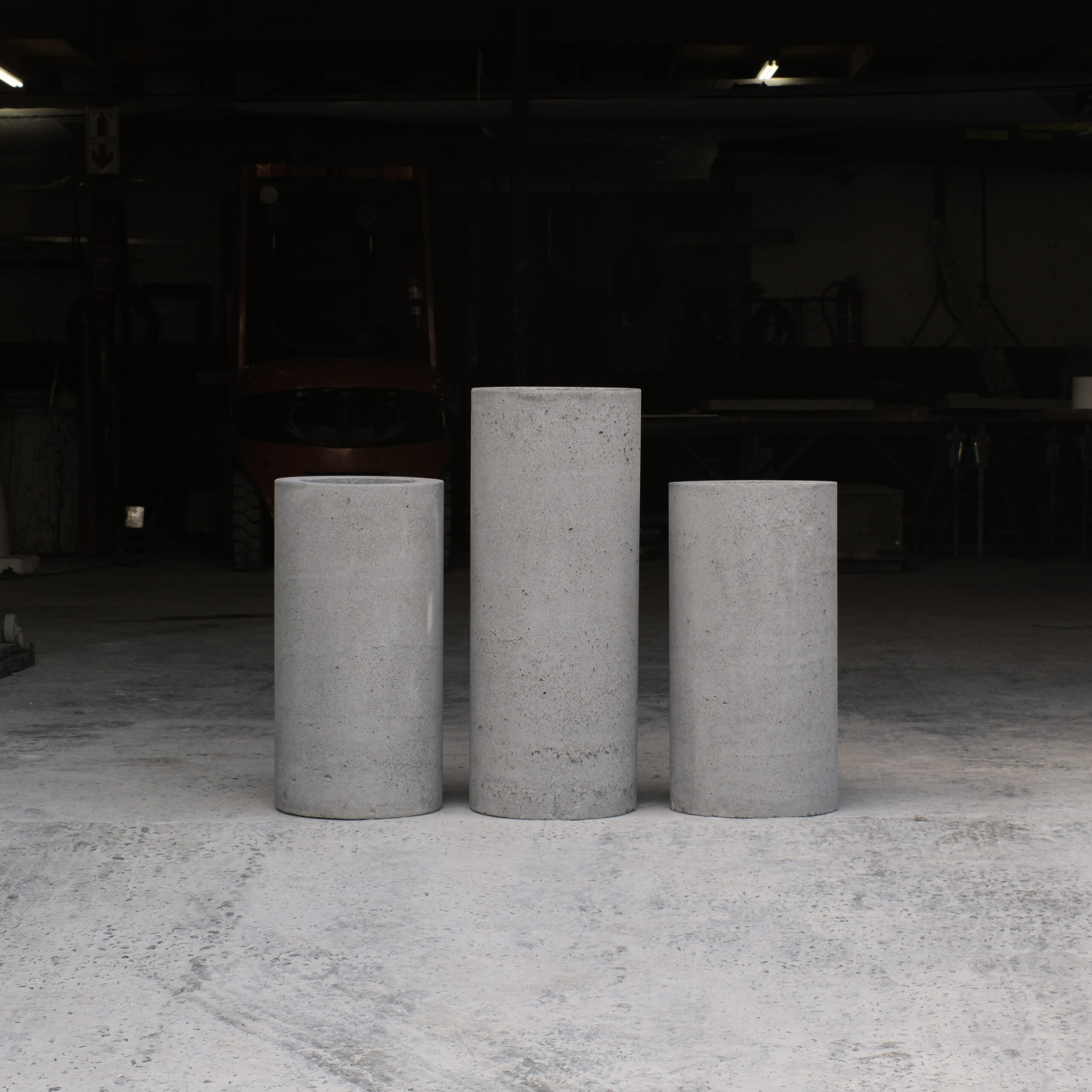 Custom Cylinder Planters 1 Three Stonecast custom round planters in a row